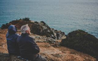 retired couple looking out over coastline